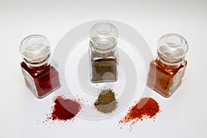 Glass spice jars with different kinds of pepper