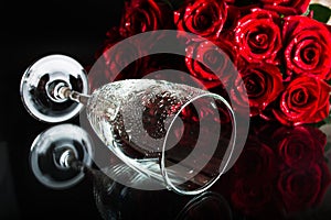 A glass with splashes of water and a bouquet of roses. Flowers of love