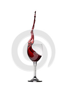 Glass of splashing red wine isolated on white