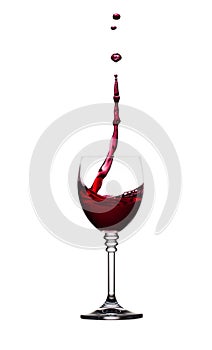 Glass of splashing red wine isolated on white