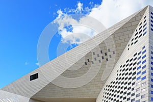 Glass and steel skyscraper on azure sky background