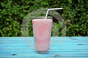 Glass of strawberries, cherries smoothie with straw on wooden table. Protein cocktail. Healthy drink. Fresh homemade smoothie. Hea