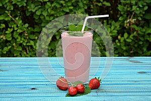 Glass of strawberries, cherries smoothie with straw on wooden table. Protein cocktail. Healthy drink. Fresh homemade smoothie. Hea