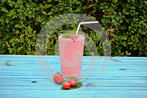 Glass of strawberries, cherries smoothie with straw on wooden table. Protein cocktail. Healthy drink. Fresh homemade smoothie. Hea