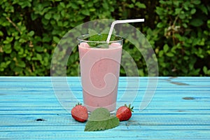 Glass of strawberries, cherries smoothie with straw on wooden table. Protein cocktail. Healthy drink. Fresh homemade smoothie. Hea