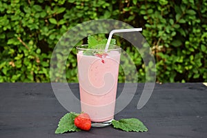 Glass of strawberries, cherries smoothie with straw on wooden table. Protein cocktail. Healthy drink. Fresh homemade smoothie. Hea