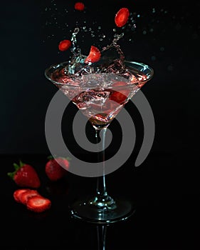 Glass with strawberry drink martini splash