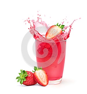Glass of strawberry juice with cut in half fruit and splashing