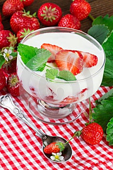 Glass with strawberry yogurt dessert. Vertical image photo
