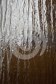 Glass surface with abstract pattern. Background translucent glass with a relief pattern.