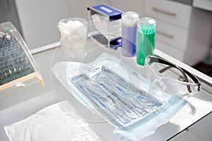 Glass table in dentist office with all necessary tools for teeth treatment