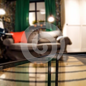 Glass table top with a blurred home interior background. Empty space background for you products and decoration.
