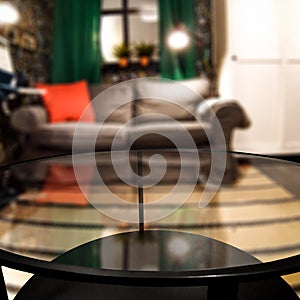 Glass table top with a blurred home interior background. Empty space background for you products and decoration.