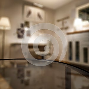Glass table top with a blurred home interior background. Empty space background for you products and decoration.