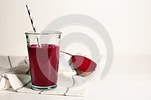 Glass of tasty beet smoothie on table