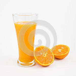 The glass of tasty pure orange juice and fresh orange half