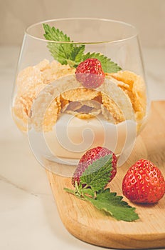 Glass of tasty strawberry dessert /Glass of tasty strawberry dessert on wooden tray, selective focus