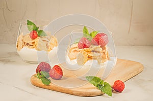 Glass of tasty strawberry dessert /two glass of tasty strawberry dessert on wooden tray, selective focus