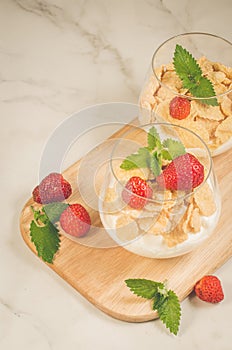 Glass of tasty strawberry dessert/two glass of tasty strawberry dessert on wooden tray, top view