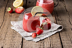 Glass of Tasty Strawberry Peach Smoothie with Lemon on Linen Napkin Wooden Background Fresh Strewberry Peach and Lemon Heathy Diet