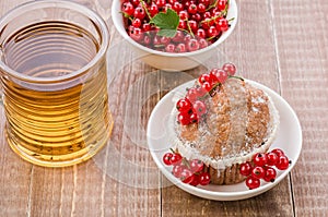 glass of tea, cake is decorated with berries and a plate with currant/glass of tea, cake is decorated with berries and a plate