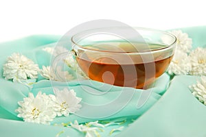 Glass tea cup and flowers
