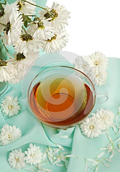 Glass tea cup and flowers