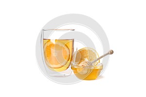 Glass of tea with lemon, honey and dipper isolated on white