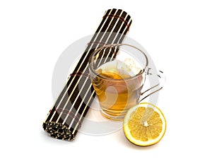 Glass of tea with a lemon on a white background