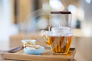 Glass of tea pot and snack in cafe shop