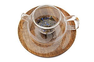 Glass tea pot with tea on the wooden plate