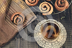 glass tea and roll with poppy on a lattice for baking/breakfast with glass tea and roll with poppy on a lattice for baking on a