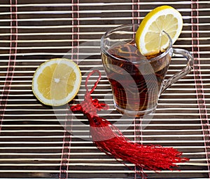Glass of tea on a rug with a lemon