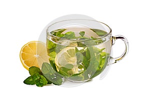 Glass teacup with herbal tea and lemon on white background