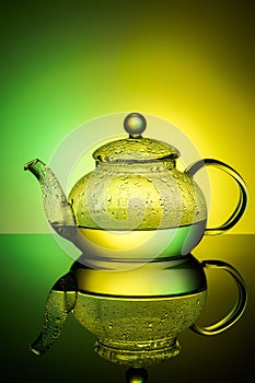 Glass teapot with boiling water and drops of condensation