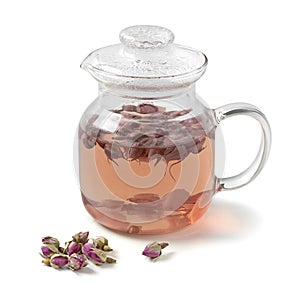 Glass teapot with dried rose buds tea on white background