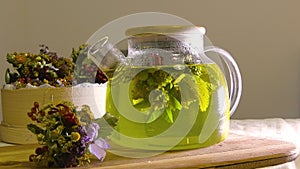 Glass teapot with freshly brewed forest herbs.