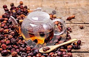 Glass Teapot of Herbal Dog Rose Tea With Dried Rosehips, Types Rosa Canina Hips Hot Drink of Medicinal Plants and Herbs Wooden