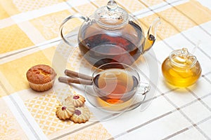 Glass teapot, mug, honney jar and cakes