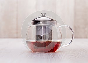 The glass teapot tea, on woodwn table