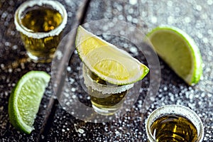 Glass of tequila, a drink of Mexican culture, made of distilled alcohol, lemon, salt and blue agave. International tequila day