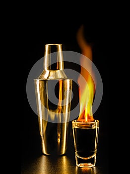 Glass with tequila shots on fire, flaming drink