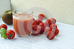 Glass of tomato juice on white background