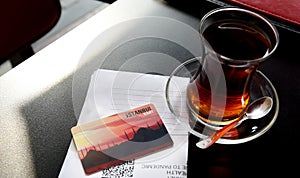 A glass of traditional Turkish tea, Istanbul transport card and HES code required to visit Turkey.