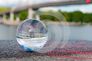 Glass transparent ball on bridge background and