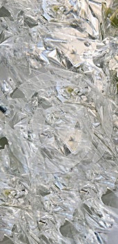 Glass transparent bottle on a white gray background broken into many fragments. Blue is a lot of fragments from under