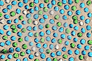 Glass transparent bright colors Small stones on sand, gravel background. Blue green abstract Texture on beige Nature