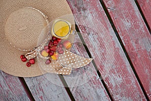 Glass of tropical exotic multifruit juice and fruits at the pier. Tropical beach picnic.