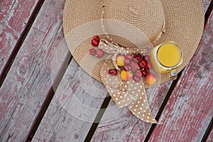 Glass of tropical exotic multifruit juice and fruits at the pier. Tropical beach picnic.