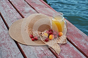 Glass of tropical exotic multifruit juice and fruits at the pier. Tropical beach picnic.